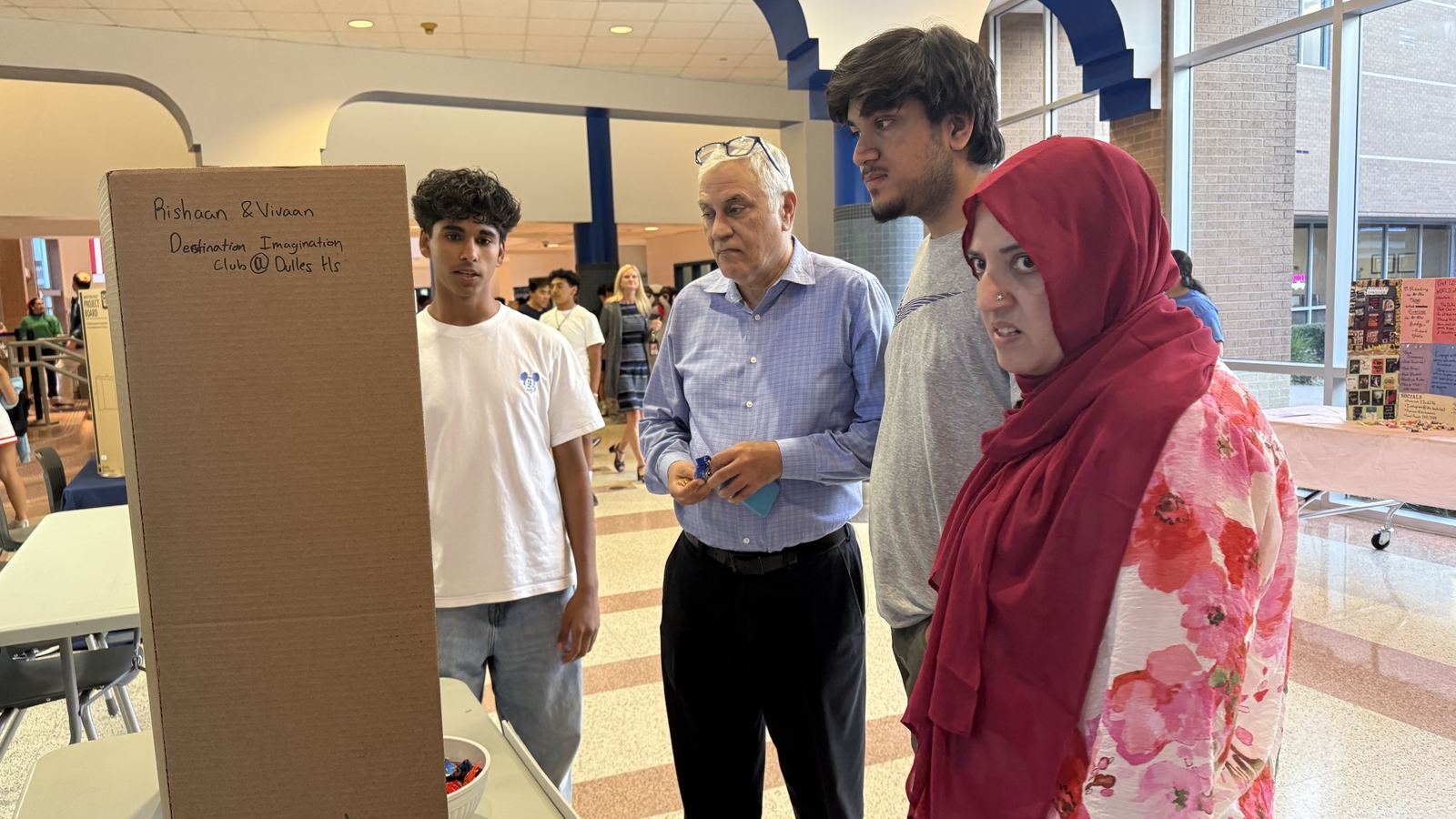 Trailblazers students talking with parents and visitors at a DI booth